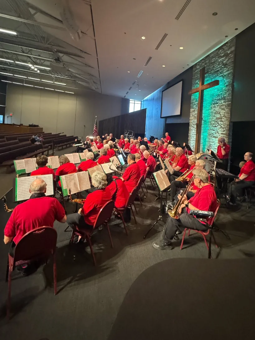 New Horizons Band musicians in red shirts performing together